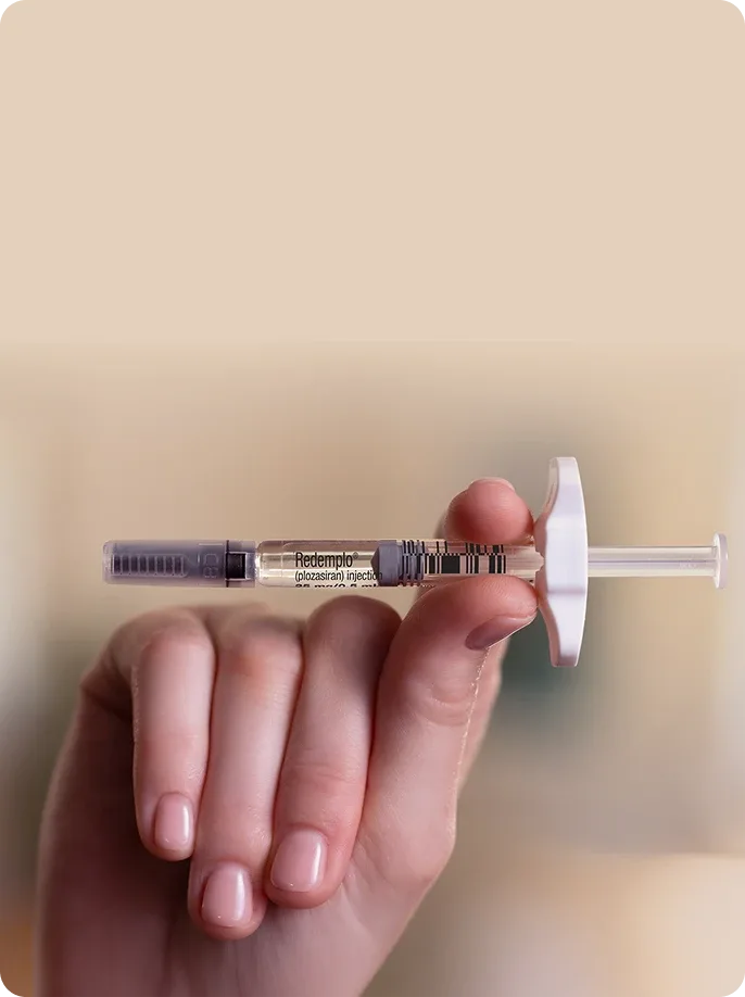 A hand holding a Redemplo® (plozasiran) injector pen
