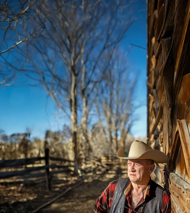 A man wearing a cowboy hat outdoors