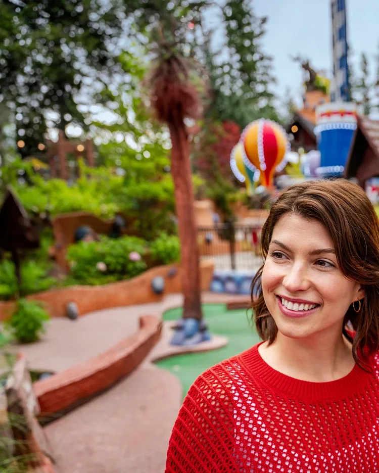 A woman at a theme park smiling